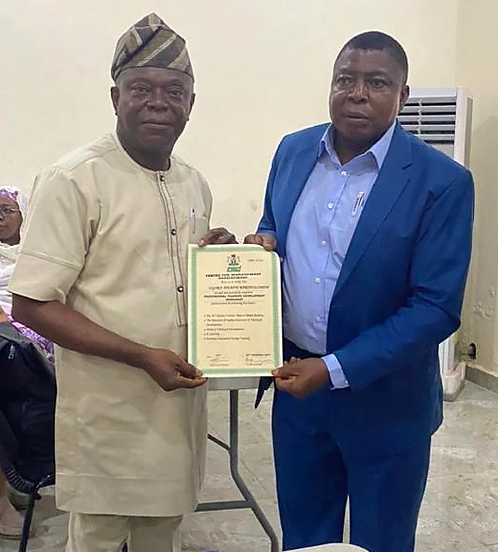 Ugorji Ifeanyi receiving a certificate from the Director of the Centre for Management Development, Abuja