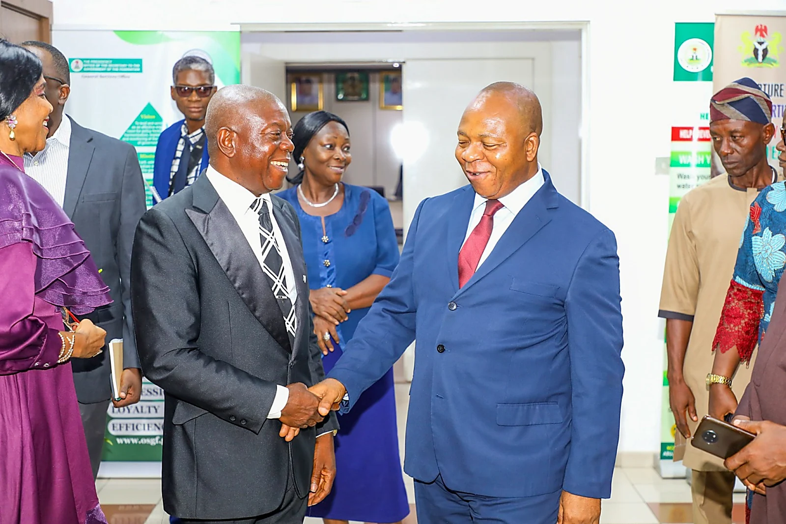 Ugorji Ifeanyi shaking hands with Dr. Maurice Nnamdi Mbaeri at the Office of the Secretary to the Government of the Federation